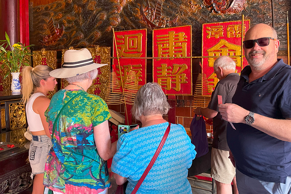 Group of guests visiting the Chinese temple in China Town.