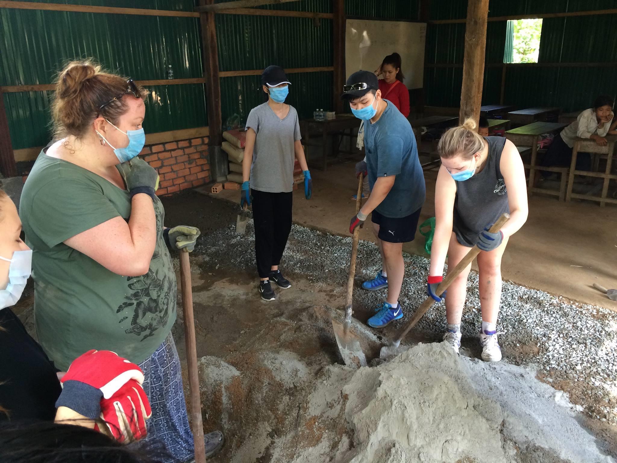 group of students gathering building the shelter in Cambodia