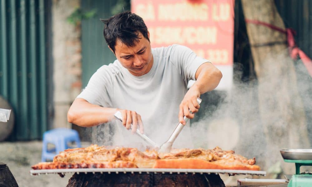 man cooking on street in Hanoi