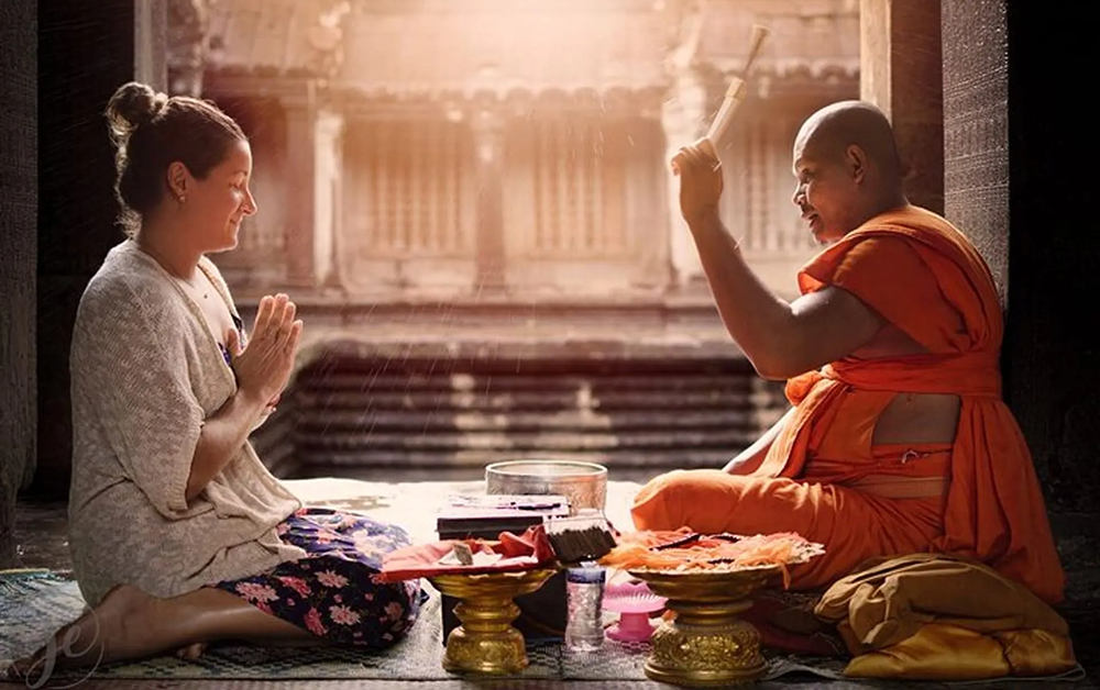 Private Jet Expeditions 24 Monk blessing in Cambodia
