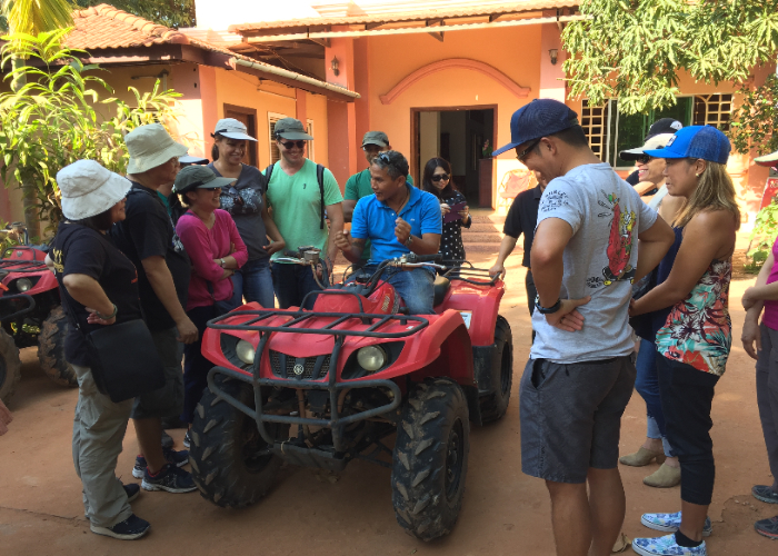 A group of travelers attending a briefing session before startign the adventure