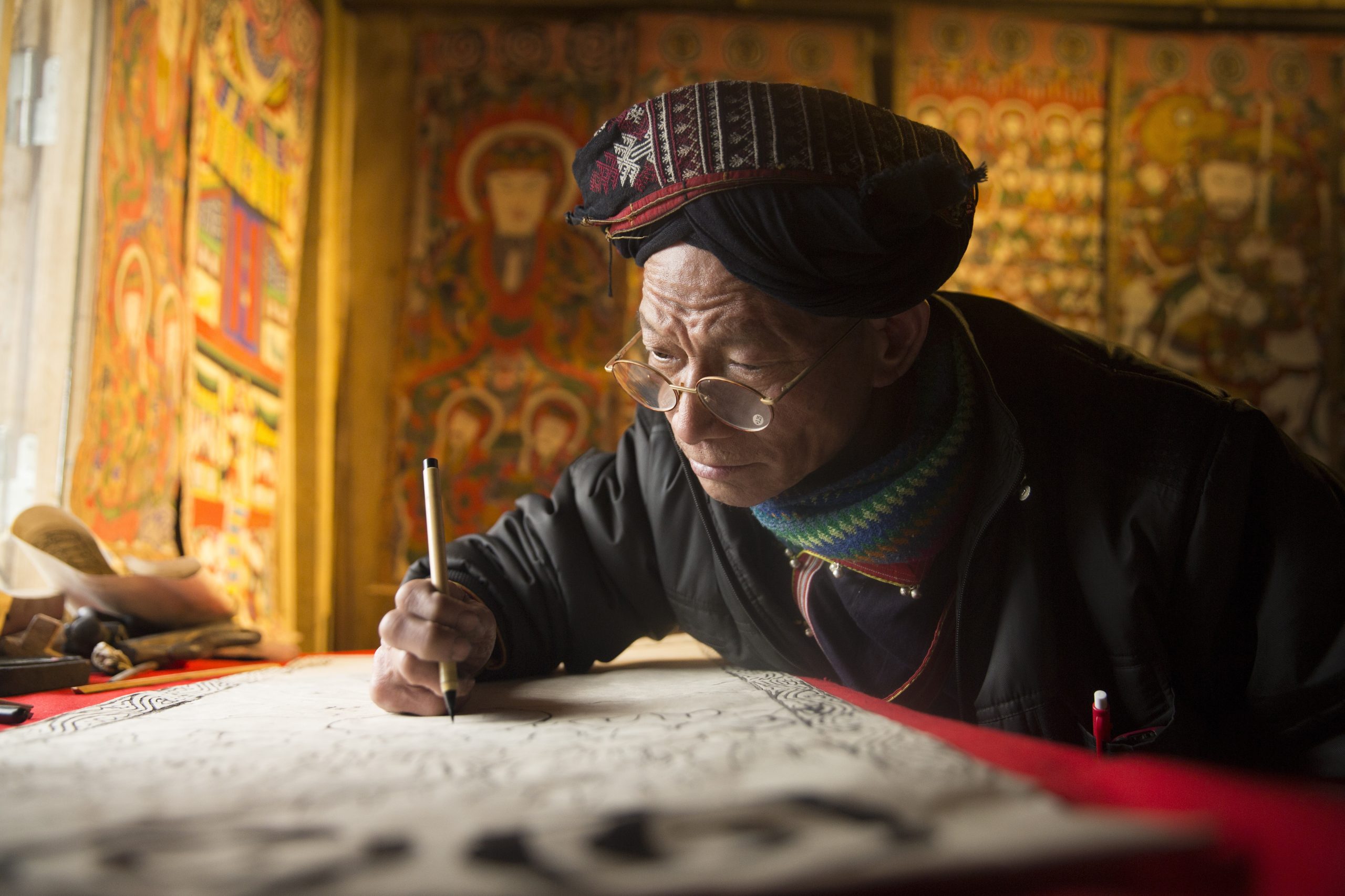 an artisan is writing old cripts