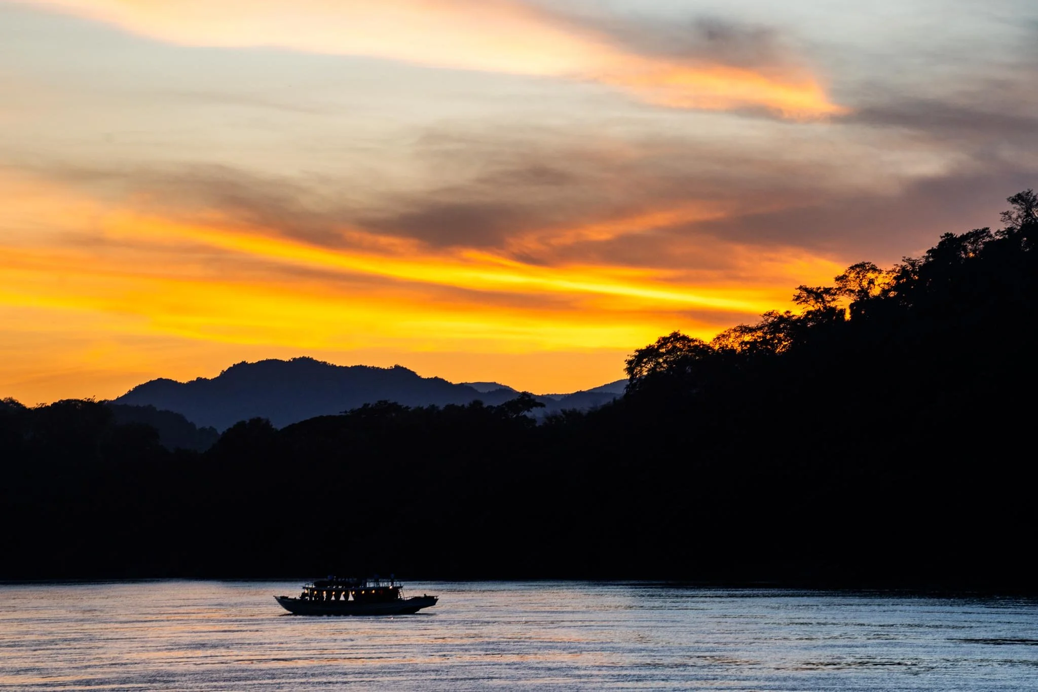 boat slowly moving on sunset